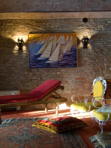 a room with a painting of sailboats on the wall at Villa Althea in Mango