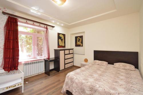 a bedroom with a bed and a window at Villa in the center of Yerevan in Yerevan
