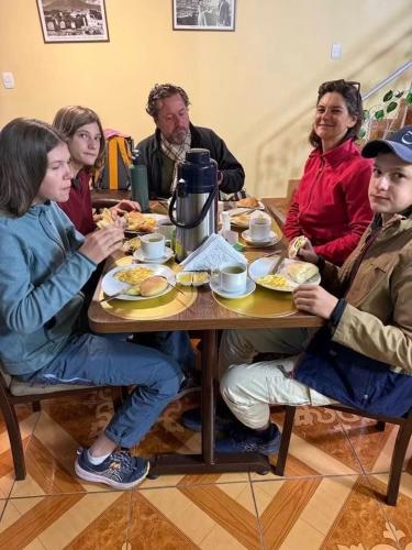 a group of people sitting at a table eating food at Kaypi Yireh in Cabanaconde
