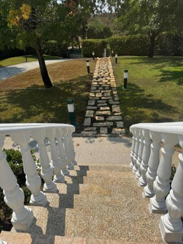 a stone path with white railings in a park at Onde a tranquilidade Reina in Recarei