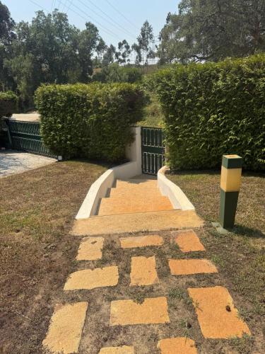 a stone path with a sign on the ground at Onde a tranquilidade Reina in Recarei