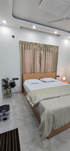 a bedroom with two beds and a window at Cherry Bloom in Chikmagalūr