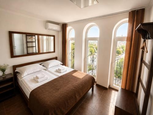 a bedroom with a bed with two towels on it at Family ЛюКс in Kamianets-Podilskyi