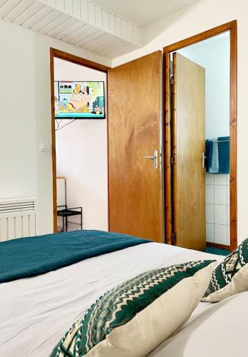 a bedroom with a bed and a sliding door at Bienvenue dans le Perche in Sainte-Céronne-lès-Mortagne