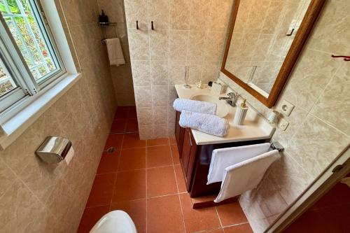 a bathroom with a sink and a mirror at Casa M&B in Las Galeras