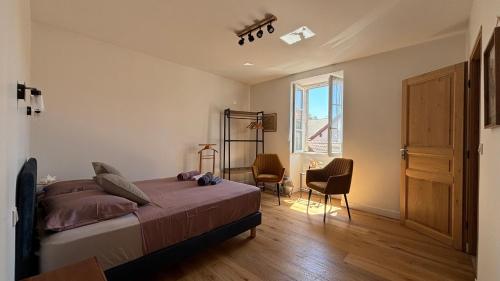 a bedroom with a bed and a window at Le Bellevue in Excénevex