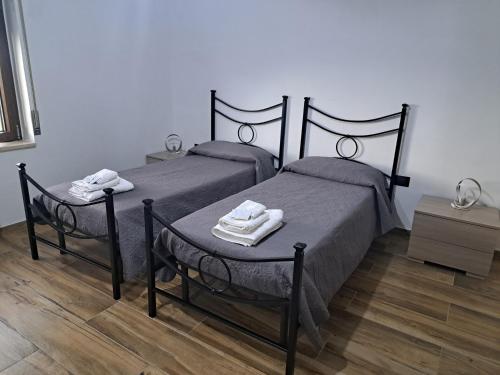 two beds in a bedroom with two towels on them at Valle degli Alburni in Postiglione