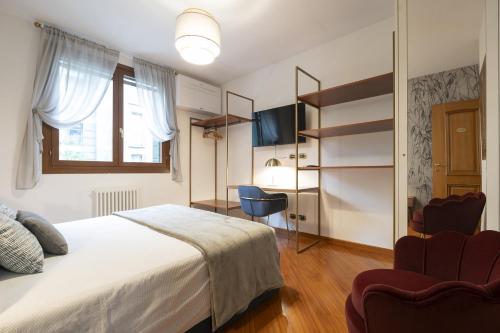 a bedroom with a bed and a table and chairs at CA' FORTE RESIDENCE in Venice