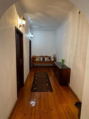 an empty room with a hallway with a table and a rug at Lentexi Inn in Lentekhi