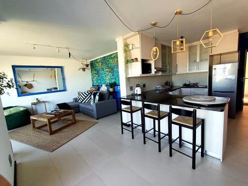 a kitchen and living room with a kitchen and a living room at Sea Spray Table View Beachfront Bliss in Cape Town