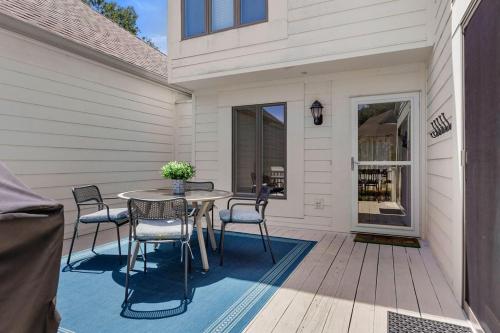 a patio with a table and chairs on a deck at 735 Spinnaker Beach House in Seabrook Island