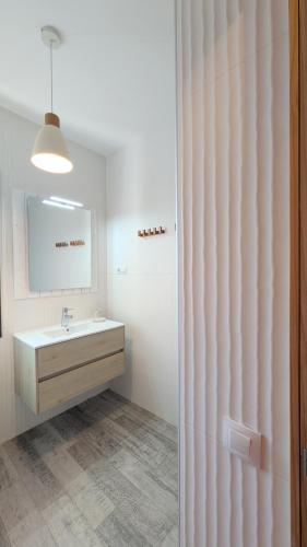 a bathroom with a sink and a mirror at Casa Cocoon, Sun&Freedom, 8 mn from beaches, internet fiber in Lajares