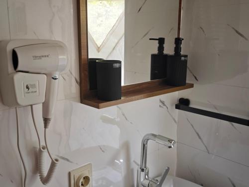 a bathroom with a hair dryer and a sink at Zarati House 