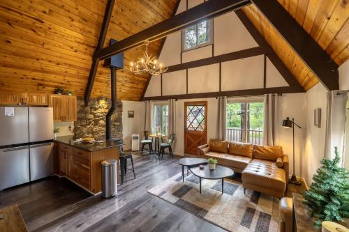 a kitchen and living room in a log home at Hotevilla A-Frame Cabin with Wi-Fi & Pine Tree Views in Flagstaff