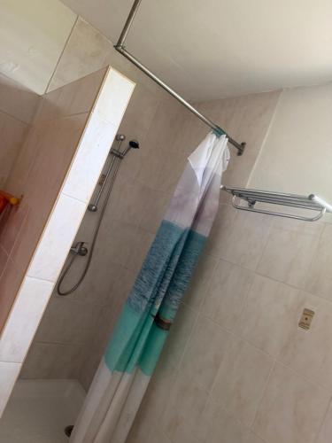 a bathroom with a shower with a shower curtain at Villa Boat red in Quartier Morne Acajou