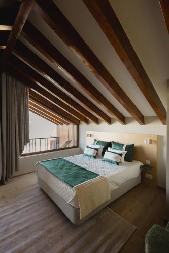 a bedroom with a large bed with a large window at KV Residences 