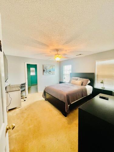 a bedroom with a bed and a desk in it at Grand Springwater Estate in Savannah