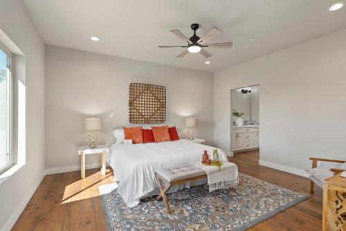 a bedroom with a bed and a ceiling fan at Megginson Apartments in Dasmariñas