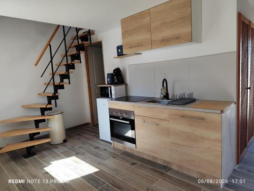 a kitchen with a sink and a stove top oven at Ty eno in Plourin