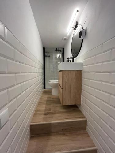 a bathroom with a sink and a toilet on a wall at El Palomar in El Arenal