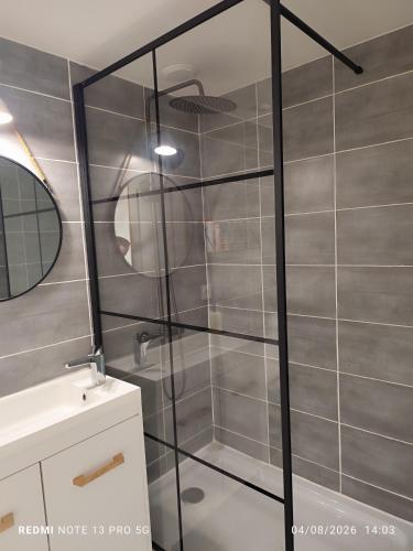 a shower with a glass door in a bathroom at Ty eno in Plourin