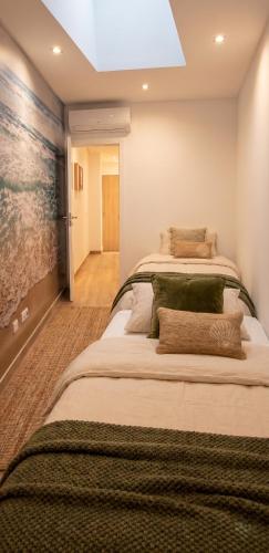 a bedroom with a large bed in a room at Casa da Mouraria in Faro