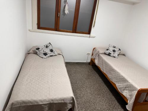 a room with two beds and a mirror at French in Tres Arroyos