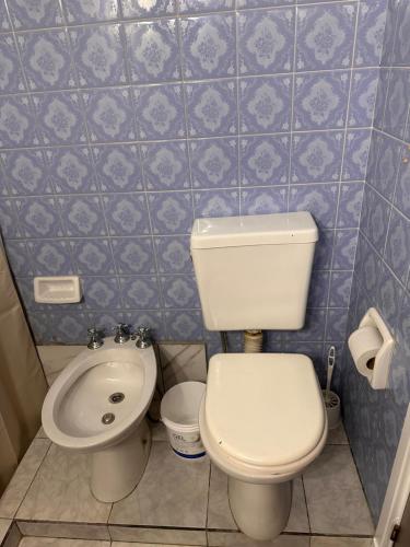 a small bathroom with a toilet and a bidet at French in Tres Arroyos