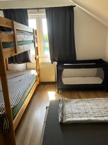 two bunk beds in a room with a window at Biser jezera in Gornja Šuma