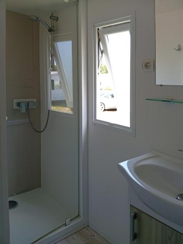 a bathroom with a shower and a sink at FH Mobile home Camping des Viviers in Lège-Cap-Ferret