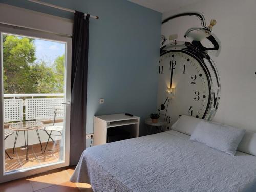 a bedroom with a large clock on the wall at Hotel Marisma Sancti Petri in Chiclana de la Frontera