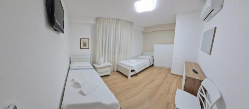 a small room with two beds and a mirror at Casa Scrivani in Pineto