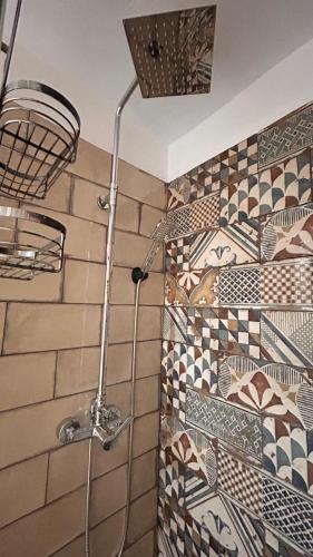 a shower in a bathroom with tiles on the wall at La posada del Cani in Cómpeta