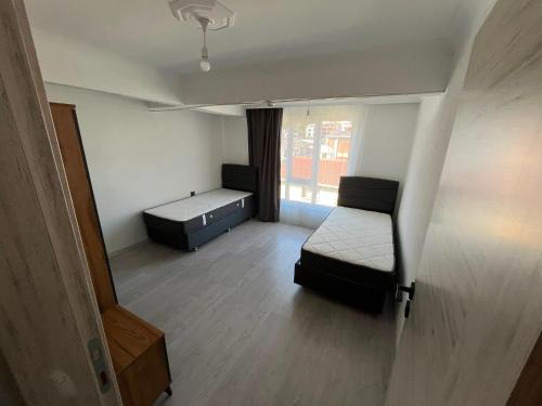 a small room with a bed and a window at Raif Arda Apart in Marmara