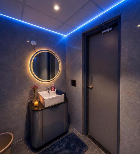 a bathroom with a sink and a mirror at Myro stays in Ghaziabad