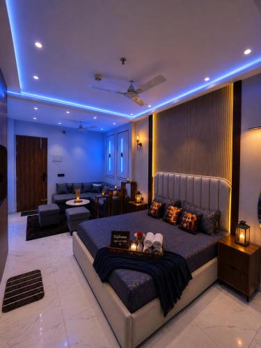 a bedroom with a large bed and a living room at Myro stays in Ghaziabad