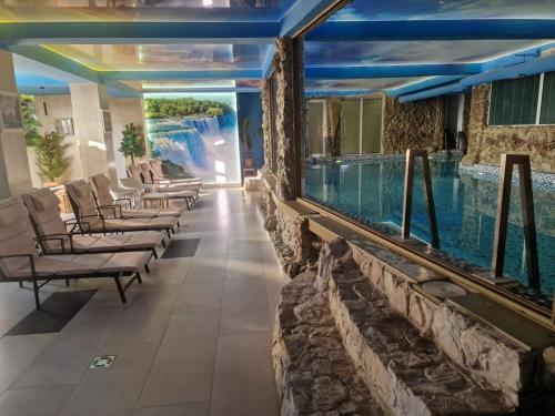 a pool in a hotel with lounge chairs and a swimming pool at Faraon apartmani Beograd in Belgrade