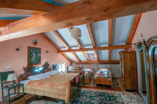 a bedroom with a large bed and wooden ceilings at Pri Macku in Tolmin