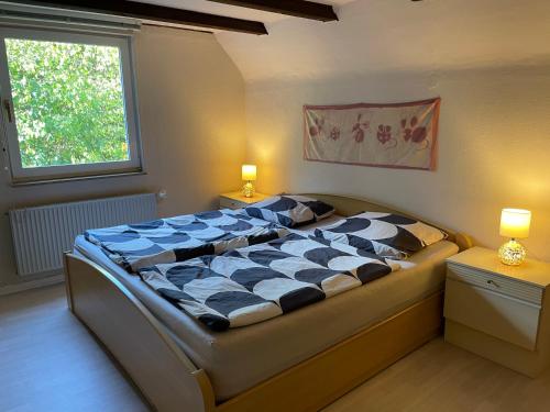 a large bed in a bedroom with two lamps at To Huus bei Hanne 