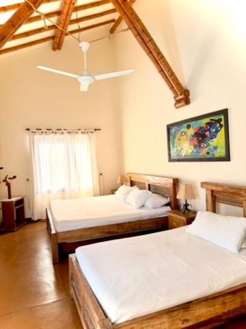 a bedroom with two beds and a ceiling fan at Fincas Panaca Herreria 23 in Quimbaya