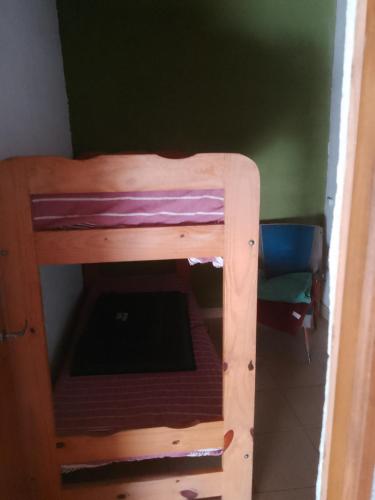 a bunk bed in a room with a ladder at casa en toninas in Las Toninas