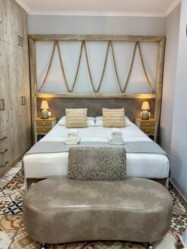 a bedroom with a large bed and a chair at Villa Kaldera Skiathos in Skiathos