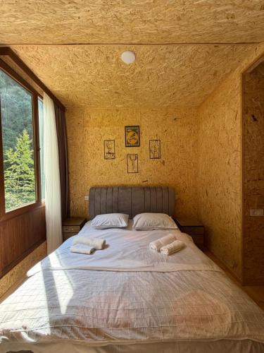a bedroom with a bed with two towels on it at Guesthouse Riverside Bagiana in Roshka