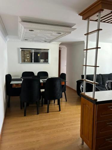a dining room with a table and black chairs at Luxurious Stay con 3 habitaciones in Bello