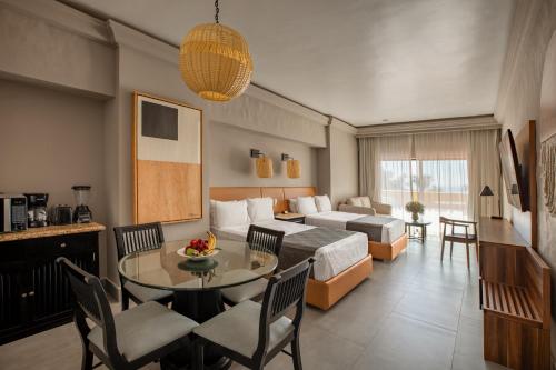 a hotel room with a bed and a table at Royal Villas Resort in Mazatlán