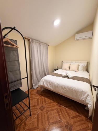 a bedroom with a large white bed and a window at Casa Misarela in Ruivãis