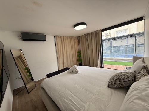 a bedroom with a large bed and a window at אחוזת רוממה - Villa Romema in Safed