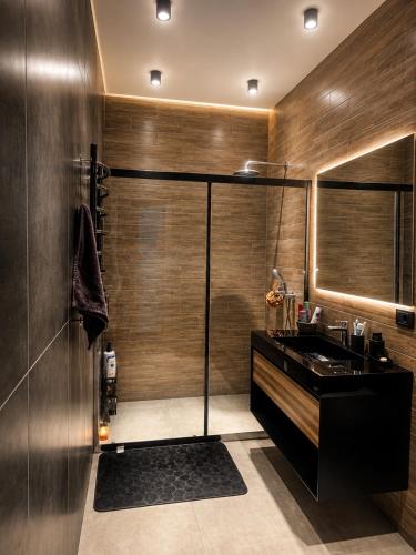 a bathroom with a shower and a sink at Cozy family apartment at Seabreeze Nardaran, Beach & Pool, Polo Residence in Baku