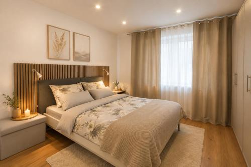 a bedroom with a large bed and a window at Ferienwohnung Bayer in Gründau