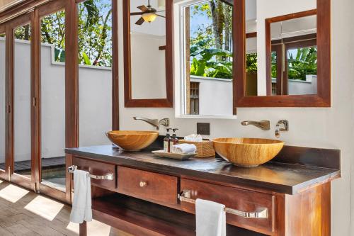 two sinks on a counter in a bathroom with mirrors at Ka'ana Resort & Spa in San Ignacio